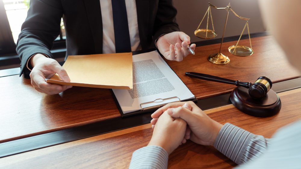 Lawyer meets with client to explain what the average settlement is for a dog bite.