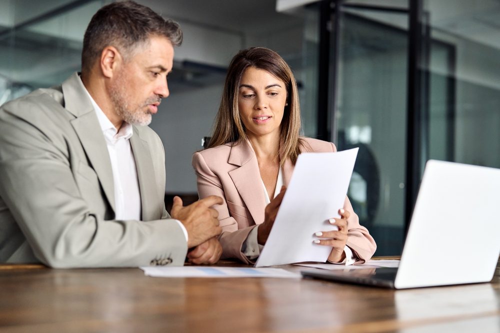An attorney reviews paperwork for a settlement regarding a slip and fall accident. Settlements from a slip and fall injury are usually not taxable in Georgia. However, exceptions could apply to your situation. Consult with an attorney or tax advisor, who will review your case.