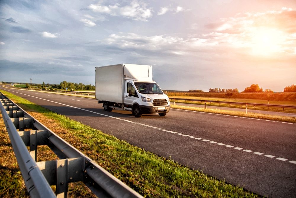 A delivery van rides down a highway, leaving other road users to wonder whether Amazon trucks are insured.