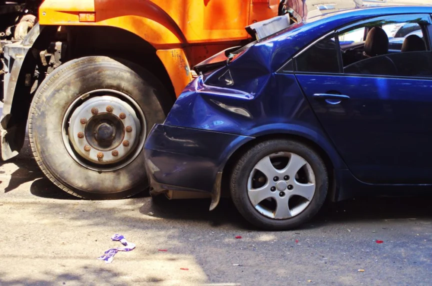 A car sits damaged after a crash with a truck. Filing a truck accident claim often involves showing that damage to an insurance company.